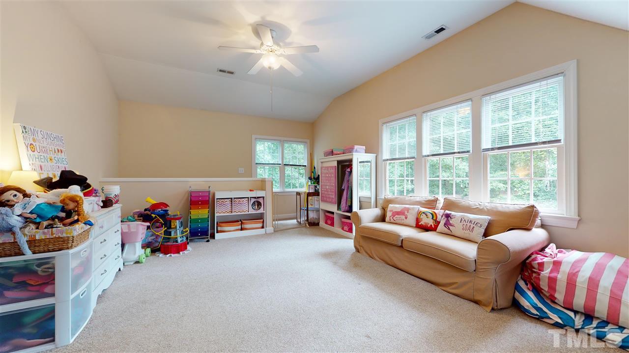8005 Millenium Drive Raleigh, NC 27614 - Photo 22 of 30 a living room with furniture and a baby crib