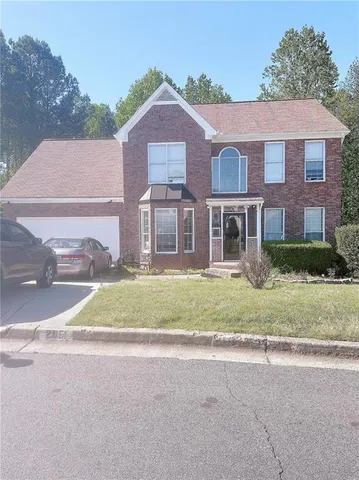 front view of a house next to a yard
