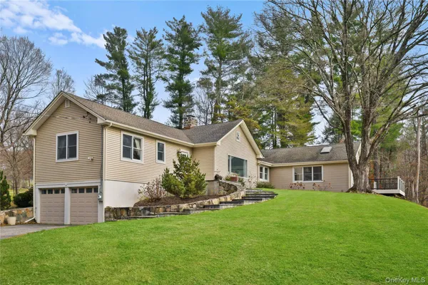 a front view of house with yard and green space
