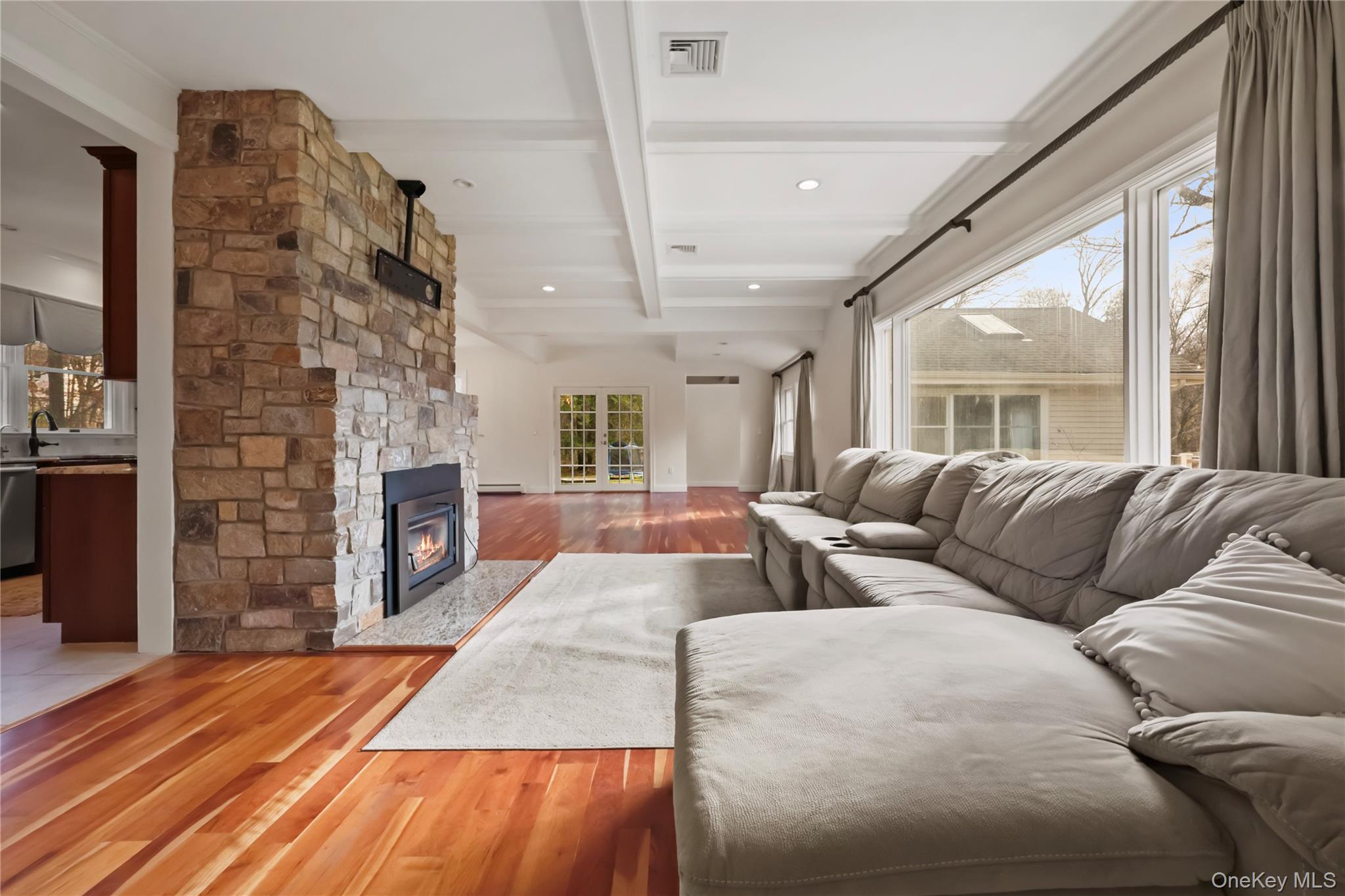 353 Turk Hill Road Brewster, NY 10509 - Photo 14 of 31 Living area featuring beamed ceiling, wood finished floors, a stone fireplace, and recessed lighting