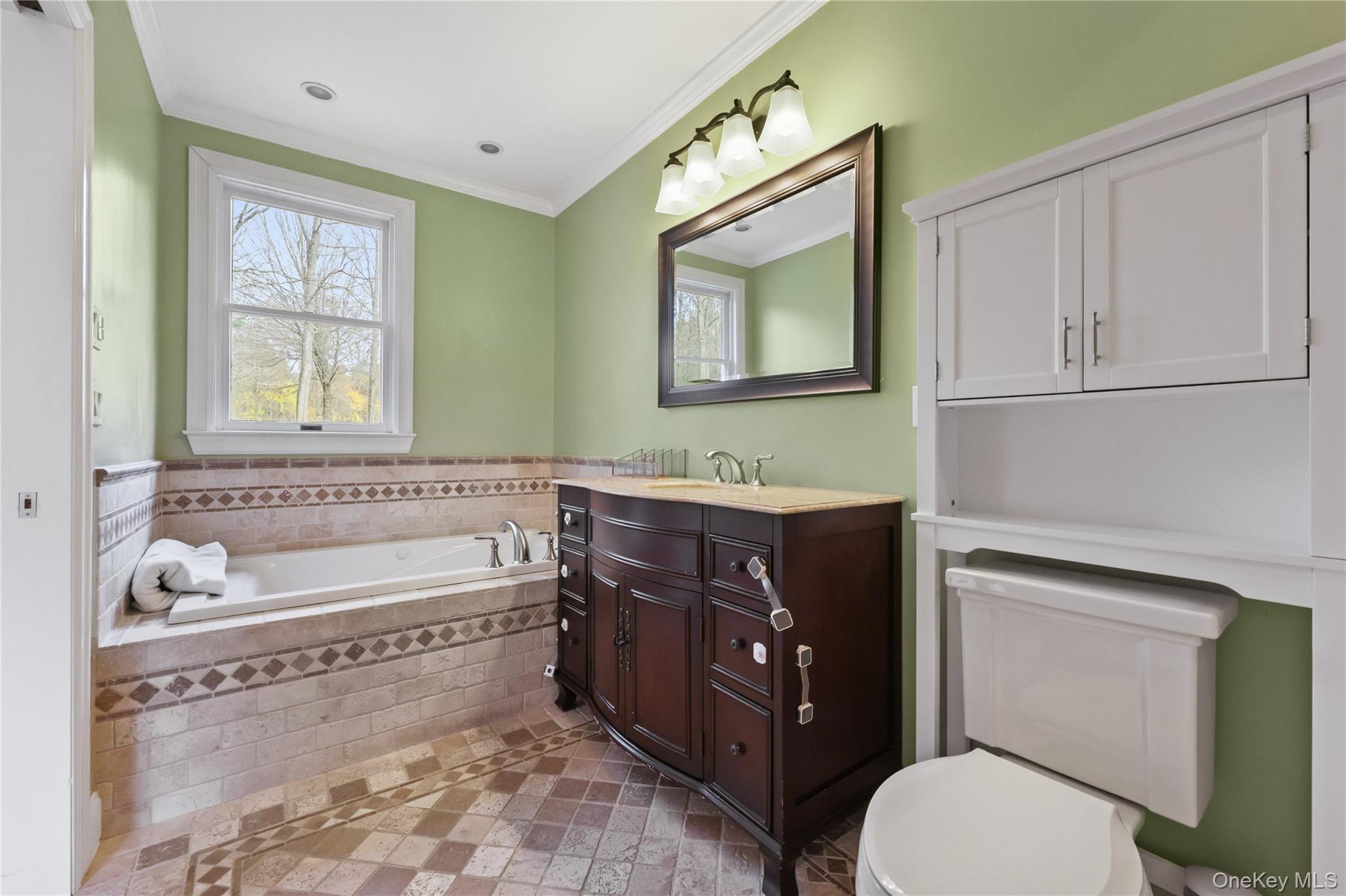 353 Turk Hill Road Brewster, NY 10509 - Photo 22 of 31 Primary Full bath featuring vanity, a garden tub, ornamental molding, and plenty of natural light