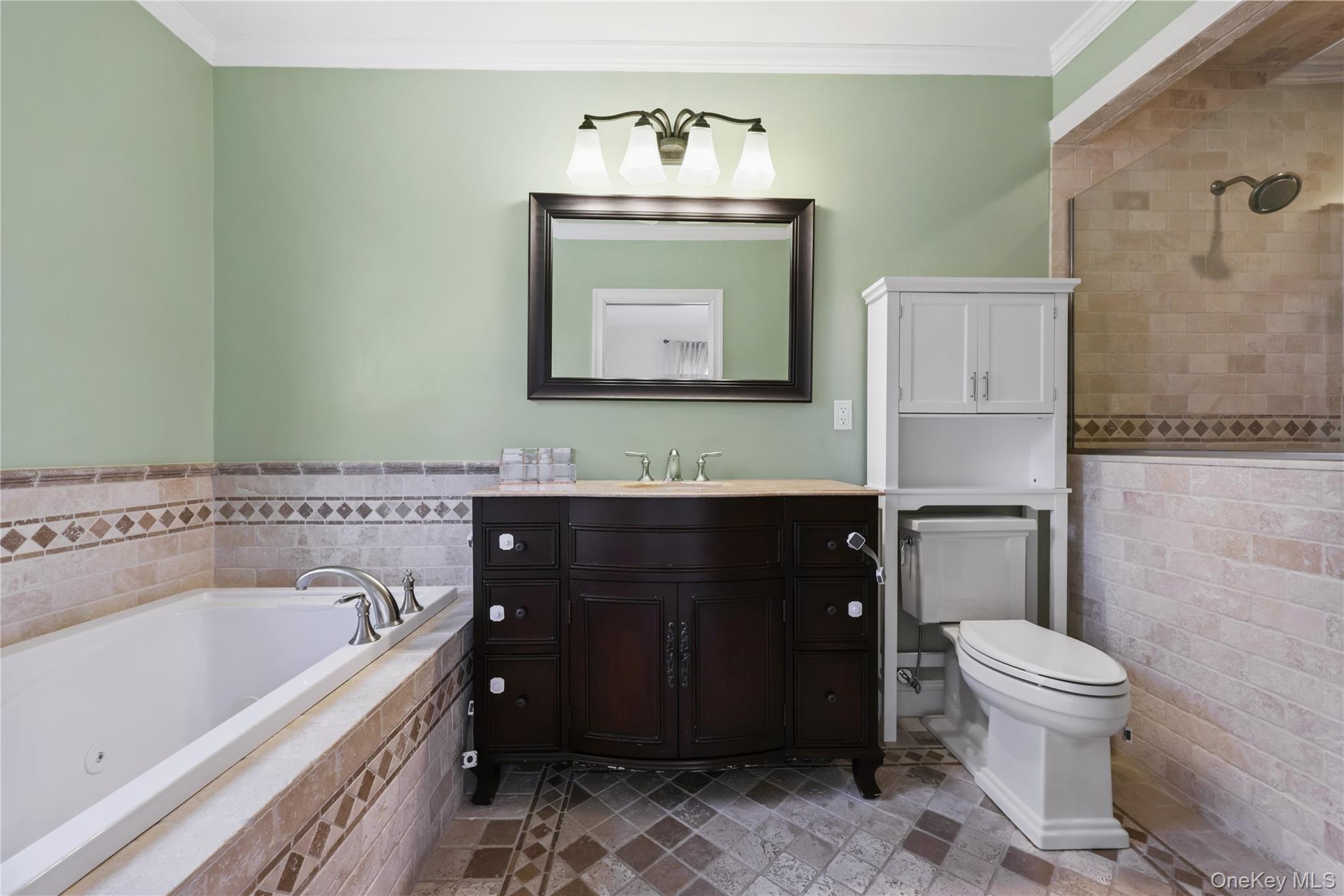 353 Turk Hill Road Brewster, NY 10509 - Photo 23 of 31 Full bathroom with vanity, a jetted tub, tile walls, a wainscoted wall, and ornamental molding