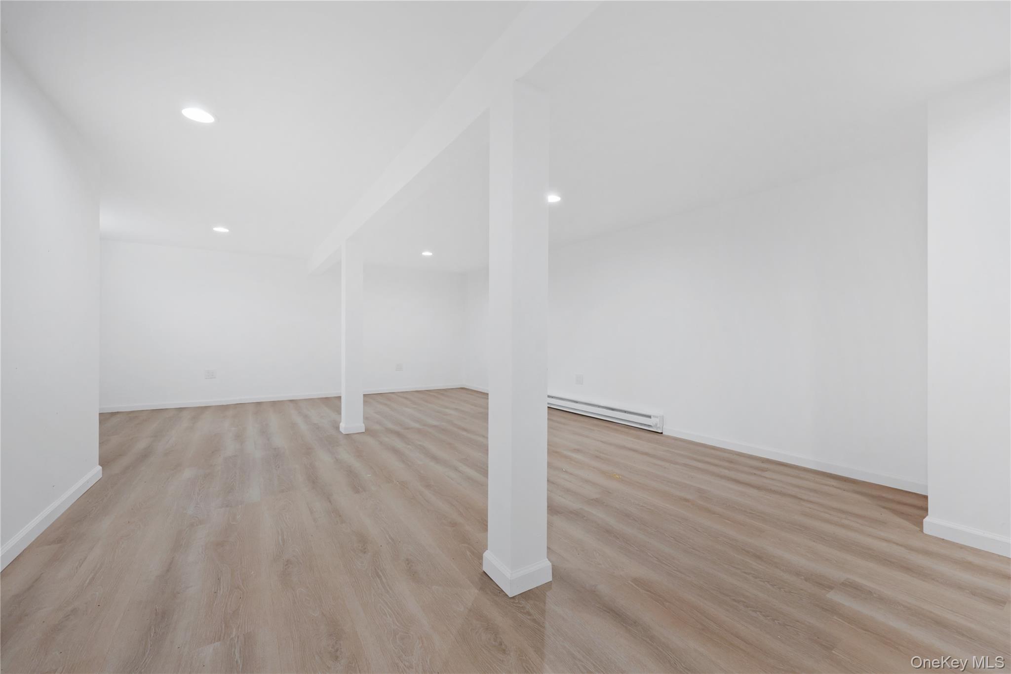 353 Turk Hill Road Brewster, NY 10509 - Photo 28 of 31 Finished basement featuring light wood finished floors, recessed lighting, and baseboard heating