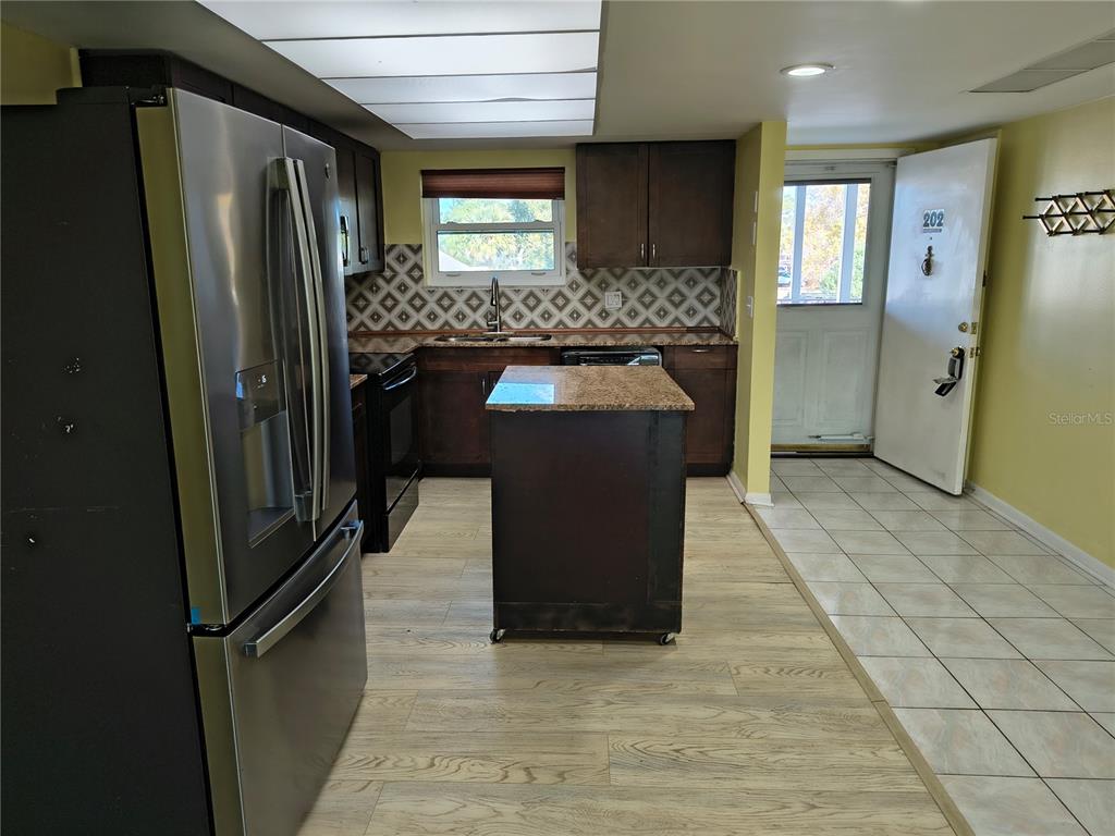 4518 Garnet Drive, Unit 202 New Port Richey, FL 34652 - Photo 11 of 66 a kitchen with stainless steel appliances granite countertop a refrigerator and a sink