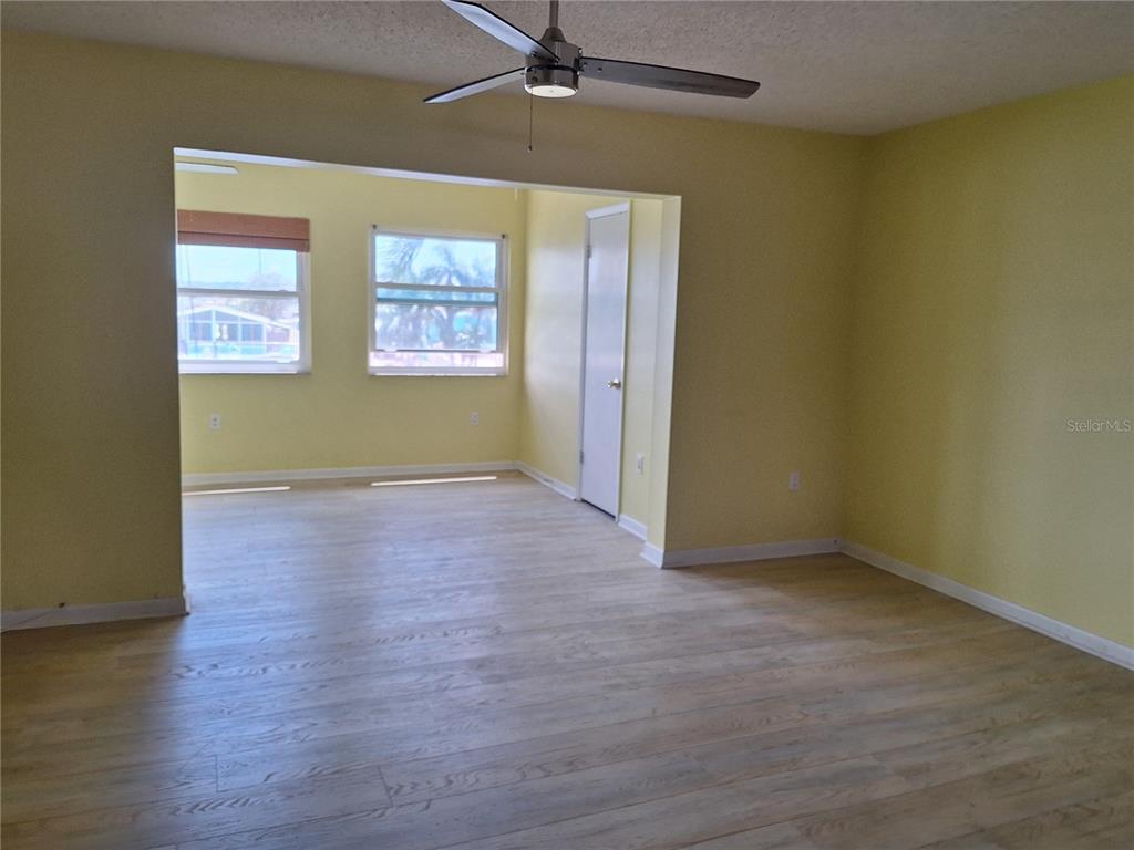 4518 Garnet Drive, Unit 202 New Port Richey, FL 34652 - Photo 16 of 66 an empty room with wooden floor a ceiling fan and windows