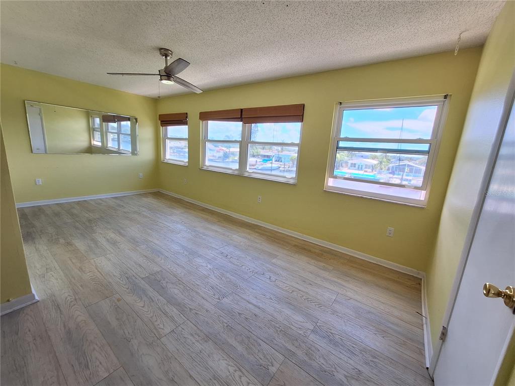 4518 Garnet Drive, Unit 202 New Port Richey, FL 34652 - Photo 17 of 66 a view of an empty room with wooden floor and a window
