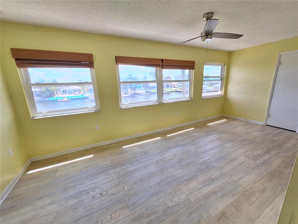 4518 Garnet Drive, Unit 202 New Port Richey, FL 34652 - Photo 18 of 66 a view of empty room with wooden floor and fan