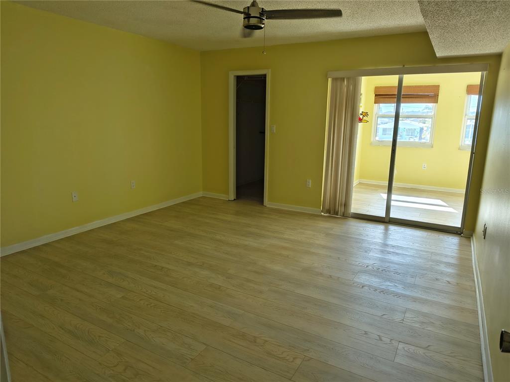 4518 Garnet Drive, Unit 202 New Port Richey, FL 34652 - Photo 22 of 66 an empty room with wooden floor and windows