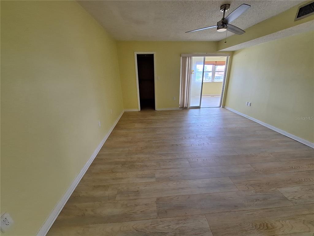 4518 Garnet Drive, Unit 202 New Port Richey, FL 34652 - Photo 23 of 66 a view of a hallway with wooden floor and windows