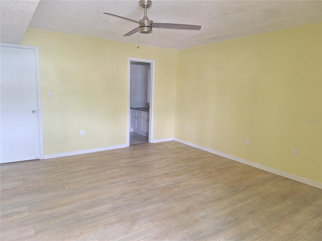 4518 Garnet Drive, Unit 202 New Port Richey, FL 34652 - Photo 24 of 66 an empty room with a empty space and a ceiling fan