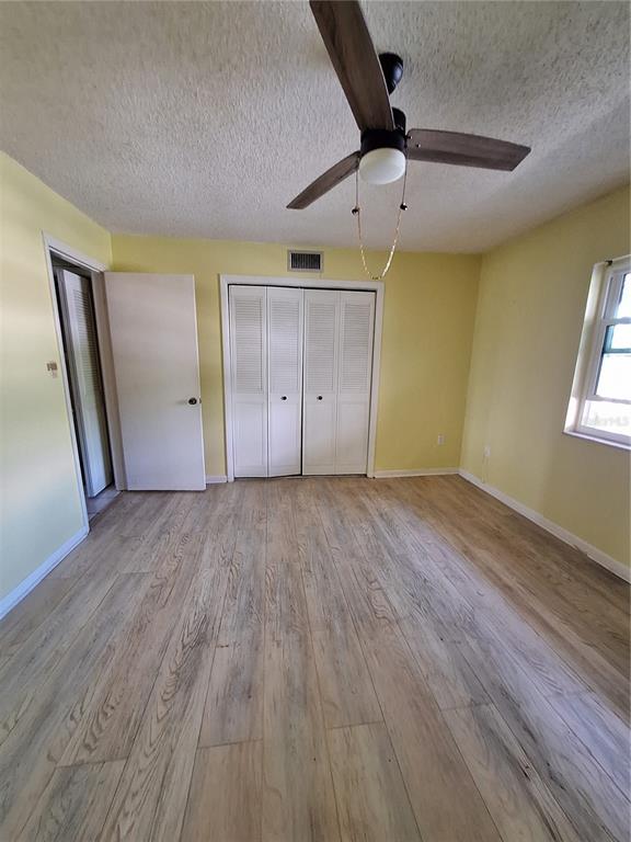 4518 Garnet Drive, Unit 202 New Port Richey, FL 34652 - Photo 32 of 66 an empty room with wooden floor and windows