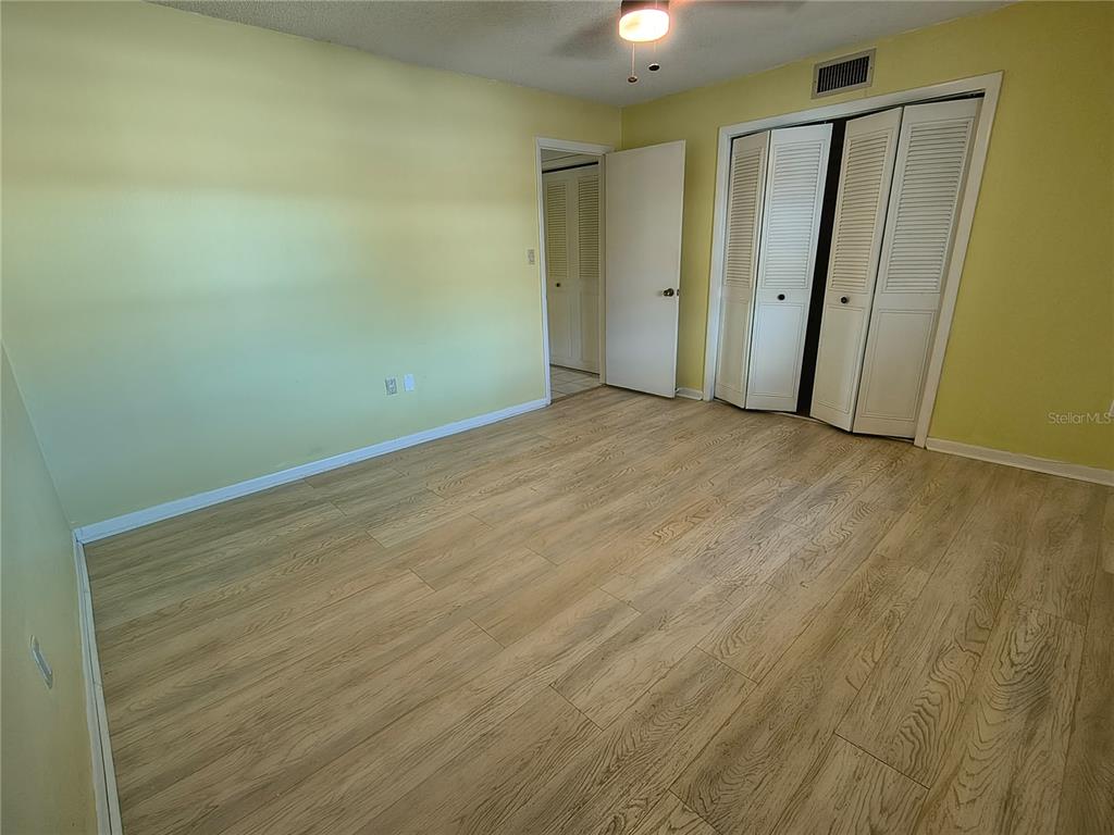 4518 Garnet Drive, Unit 202 New Port Richey, FL 34652 - Photo 33 of 66 an empty room with wooden floor