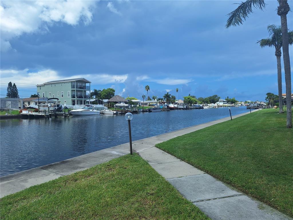 4518 Garnet Drive, Unit 202 New Port Richey, FL 34652 - Photo 40 of 66 a view of a lake with houses in the back