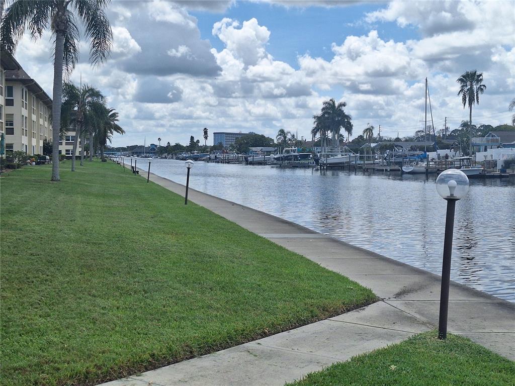 4518 Garnet Drive, Unit 202 New Port Richey, FL 34652 - Photo 48 of 66 a view of a lake with a yard