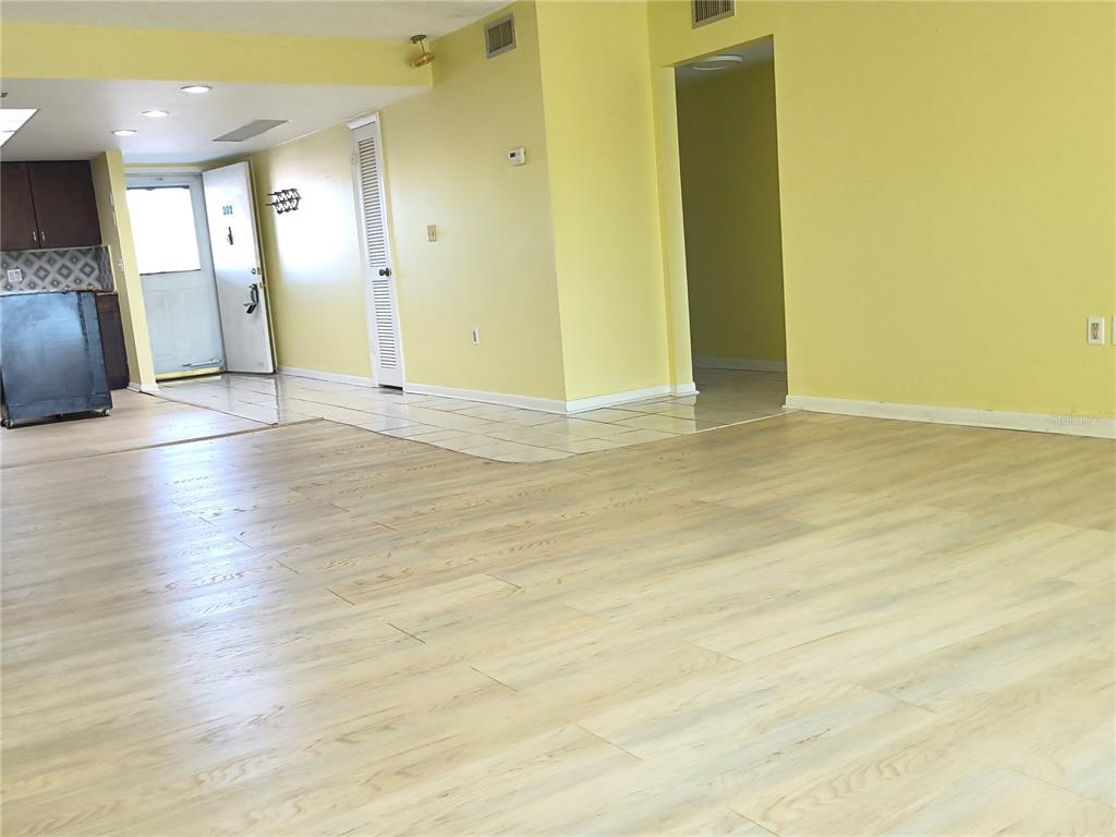 4518 Garnet Drive, Unit 202 New Port Richey, FL 34652 - Photo 5 of 66 a view of an empty room with wooden floor and a window