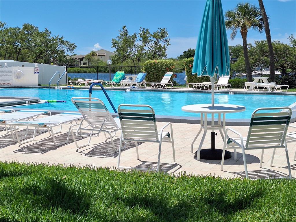 4518 Garnet Drive, Unit 202 New Port Richey, FL 34652 - Photo 61 of 66 a view of a chairs and table on the terrace