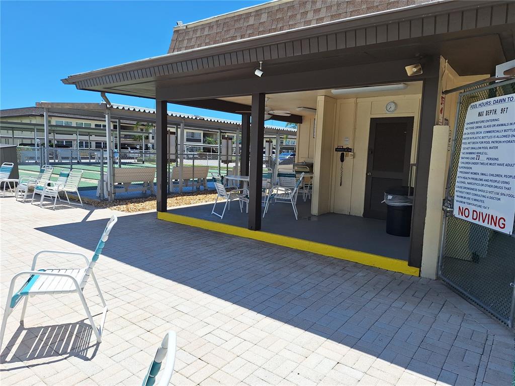 4518 Garnet Drive, Unit 202 New Port Richey, FL 34652 - Photo 65 of 66 a swimming pool with outdoor seating and yard