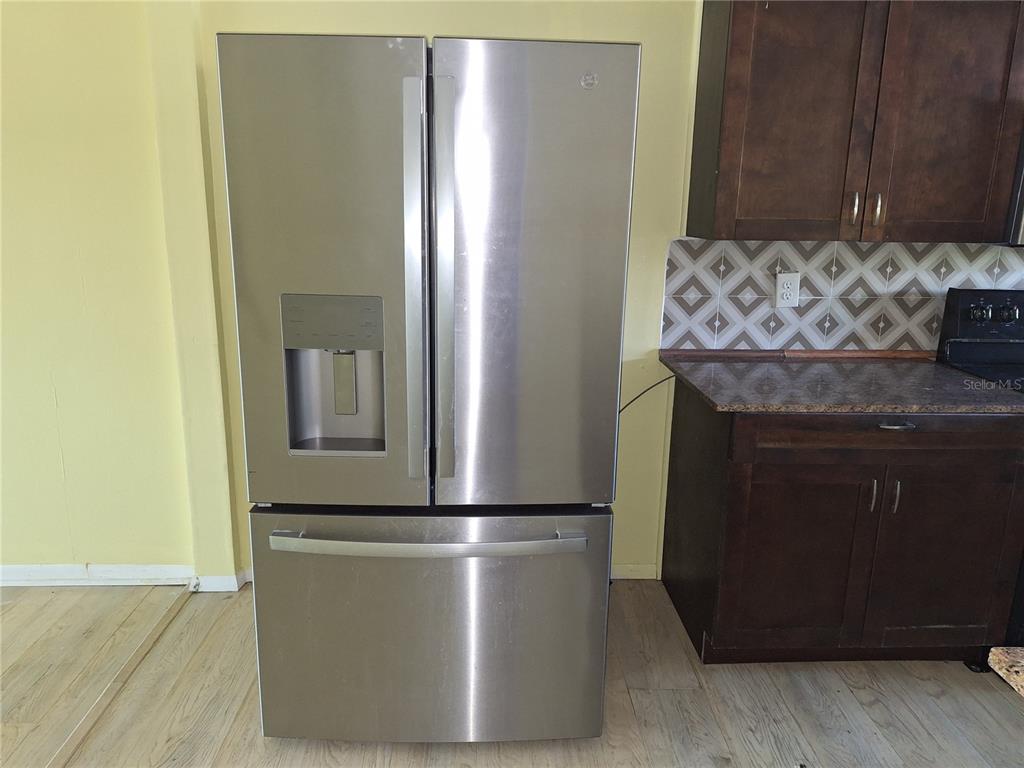4518 Garnet Drive, Unit 202 New Port Richey, FL 34652 - Photo 8 of 66 a kitchen with stainless steel appliances granite countertop a refrigerator and a stove