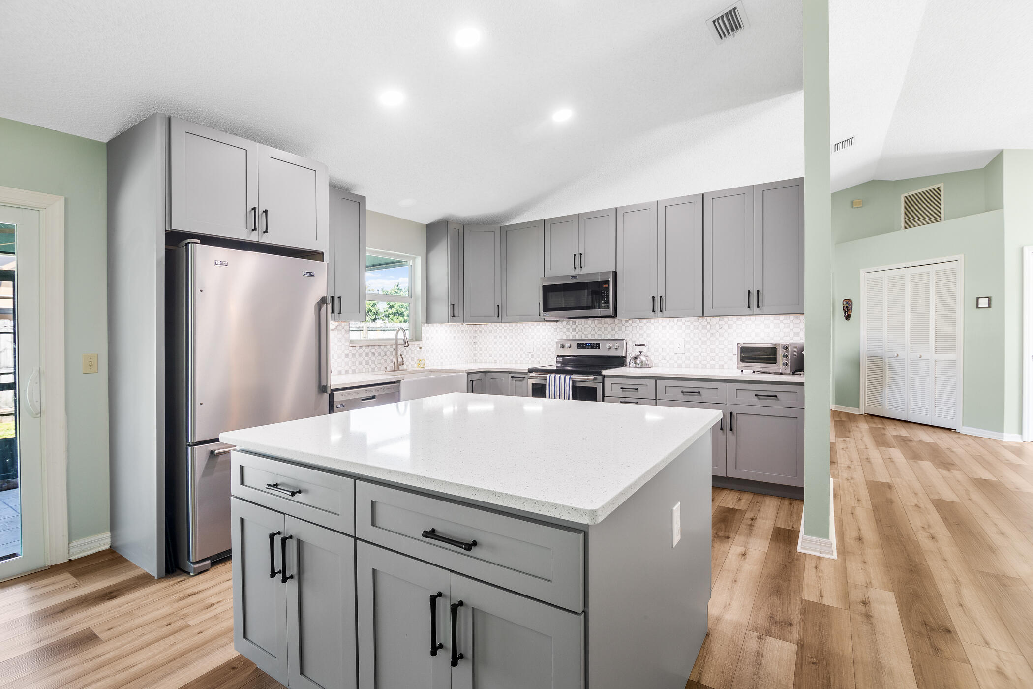 1197 Three Meadows Drive Rockledge, FL 32955 - Photo 12 of 25 a kitchen with a refrigerator a stove top oven a sink and dishwasher