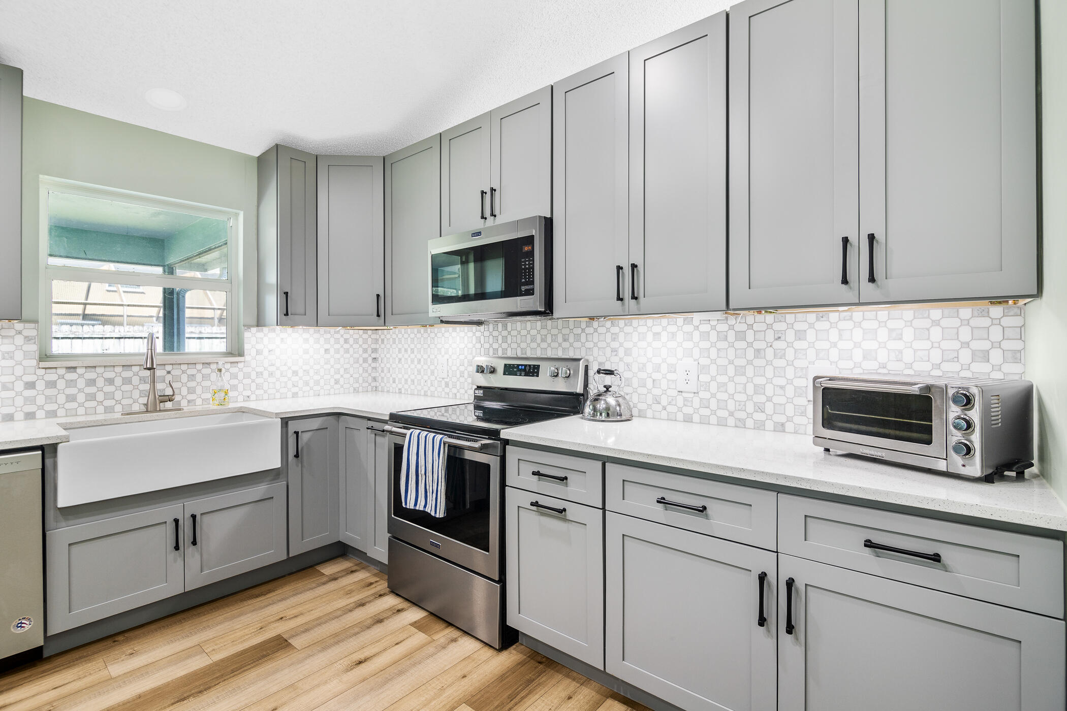 1197 Three Meadows Drive Rockledge, FL 32955 - Photo 14 of 25 a kitchen with white cabinets and white appliances