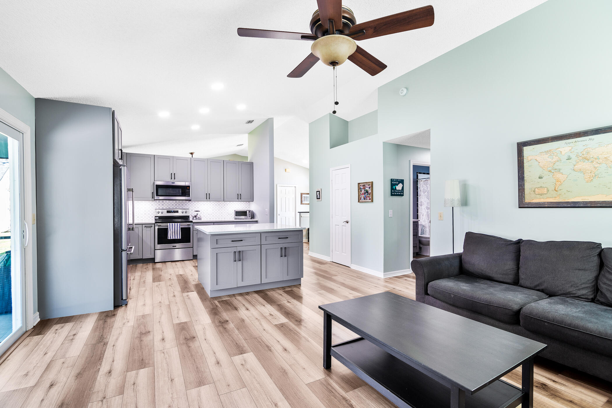 1197 Three Meadows Drive Rockledge, FL 32955 - Photo 16 of 25 a living room with stainless steel appliances kitchen island granite countertop furniture and a kitchen view