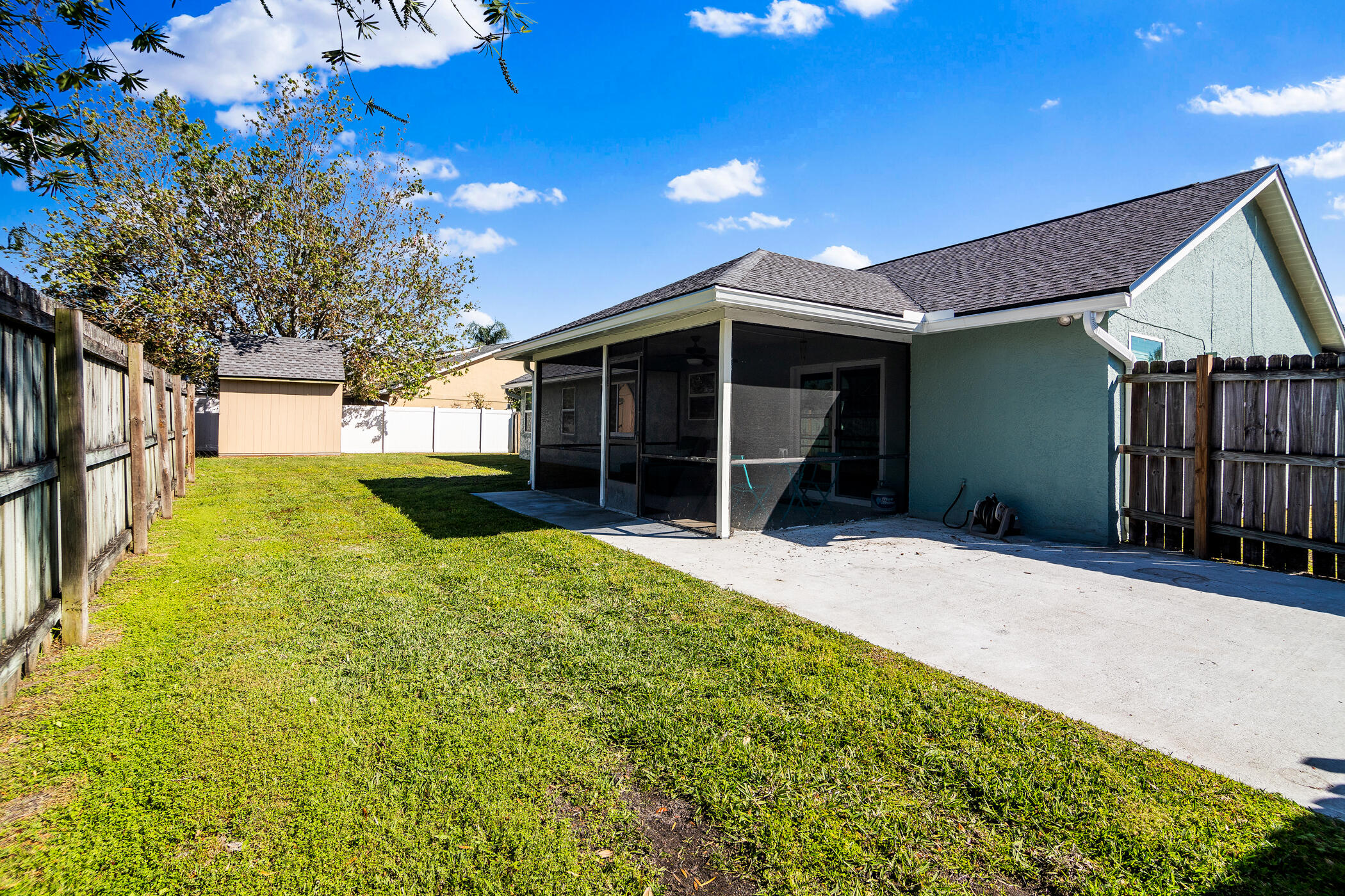 1197 Three Meadows Drive Rockledge, FL 32955 - Photo 23 of 25 a view of a backyard with a large tree