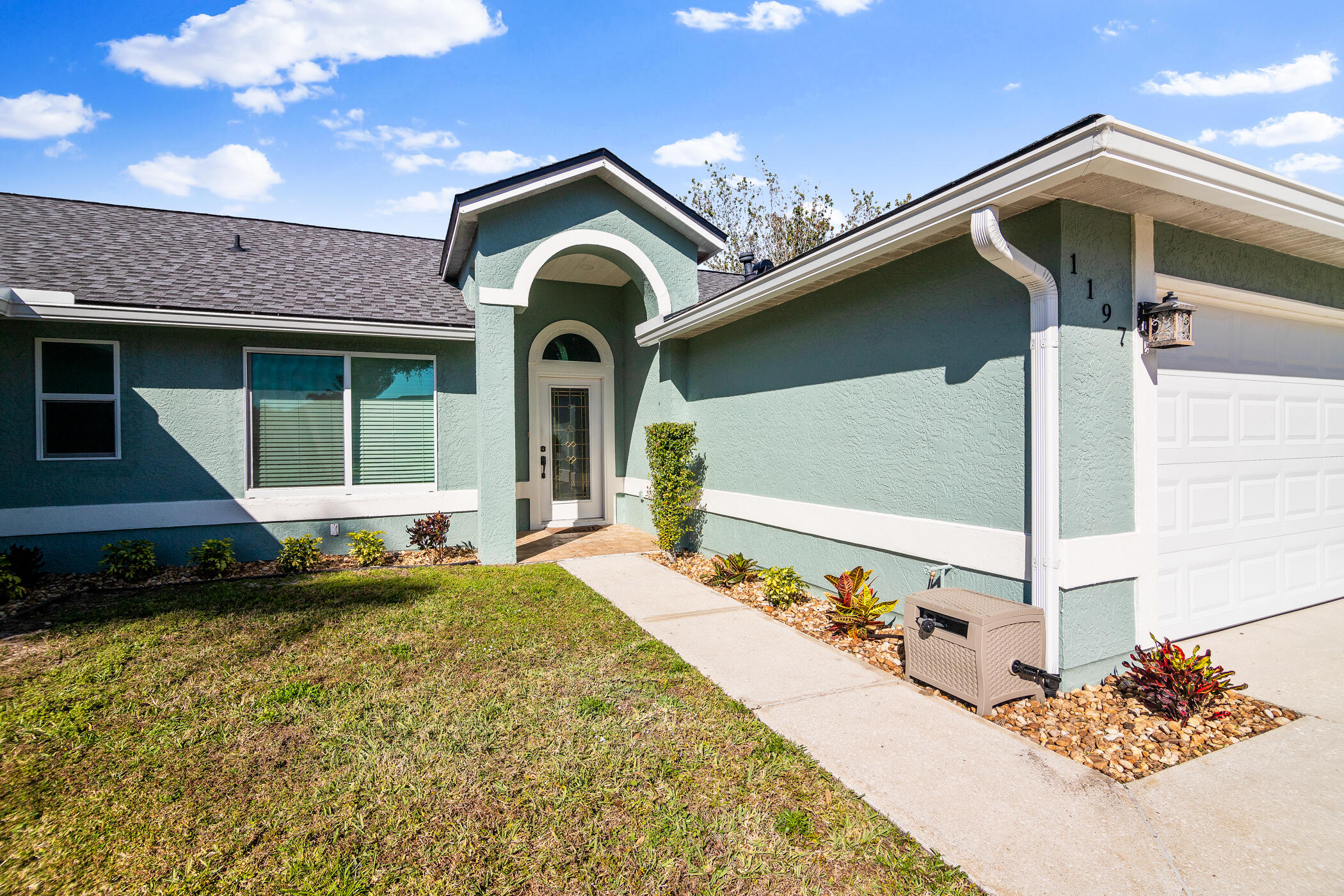 1197 Three Meadows Drive Rockledge, FL 32955 - Photo 4 of 25 a front view of a house with a yard