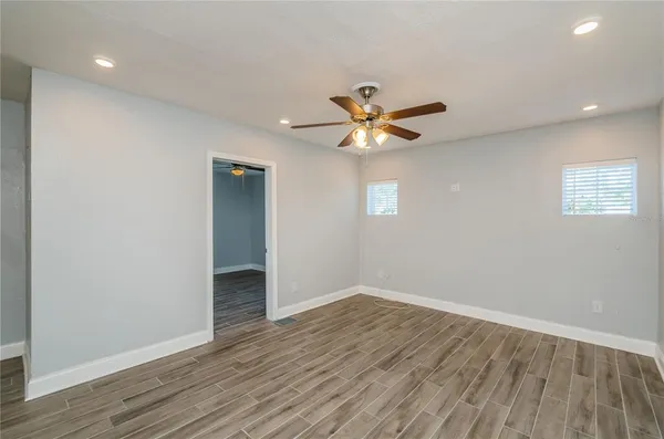 wooden floor in an empty room with a window