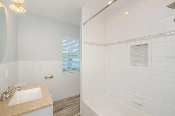 a bathroom with a bathtub and shower