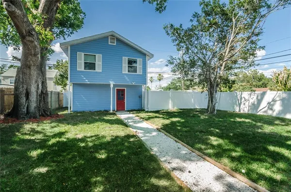 a front view of house with yard and green space