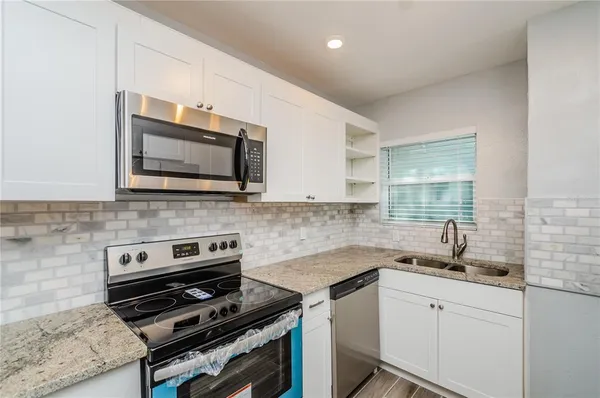 a kitchen with a stove and a microwave
