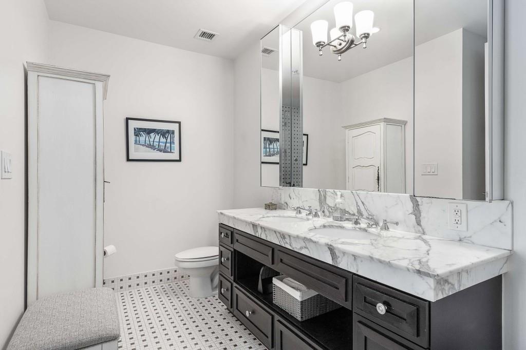 1820 Peachtree Road Northwest, Unit 1409 Atlanta, GA 30309 - Photo 19 of 44 a bathroom with a sink a toilet a mirror and shower
