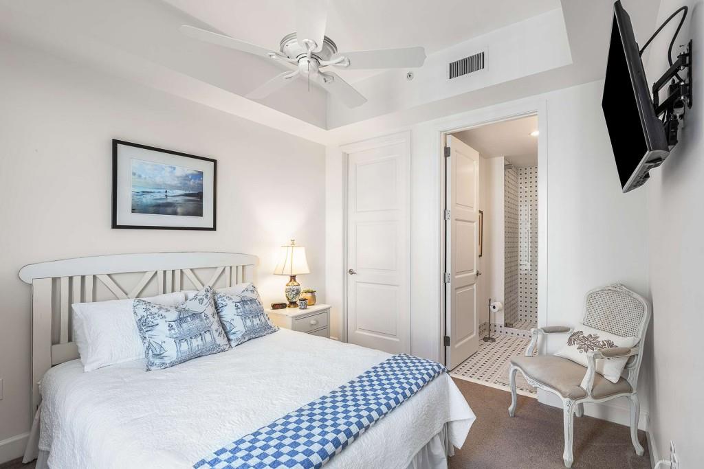 1820 Peachtree Road Northwest, Unit 1409 Atlanta, GA 30309 - Photo 20 of 44 a bedroom with a bed a mirror on dresser and a window