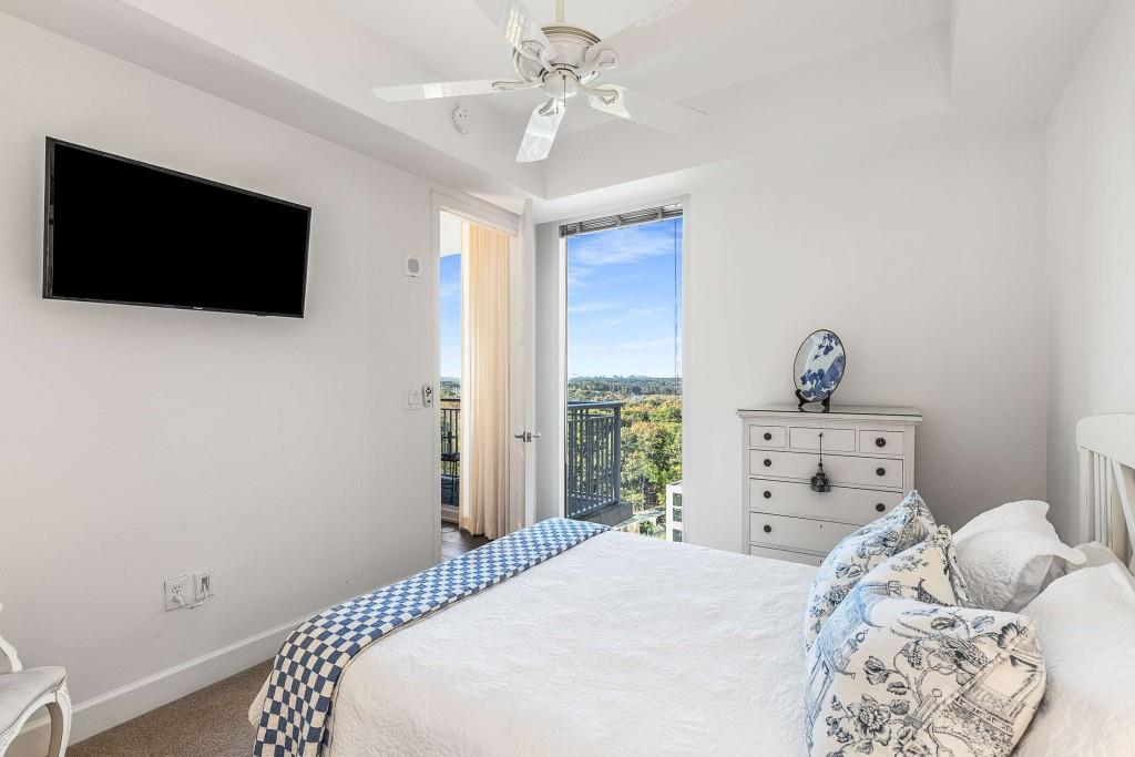 1820 Peachtree Road Northwest, Unit 1409 Atlanta, GA 30309 - Photo 21 of 44 a bedroom with a bed and a flat screen tv