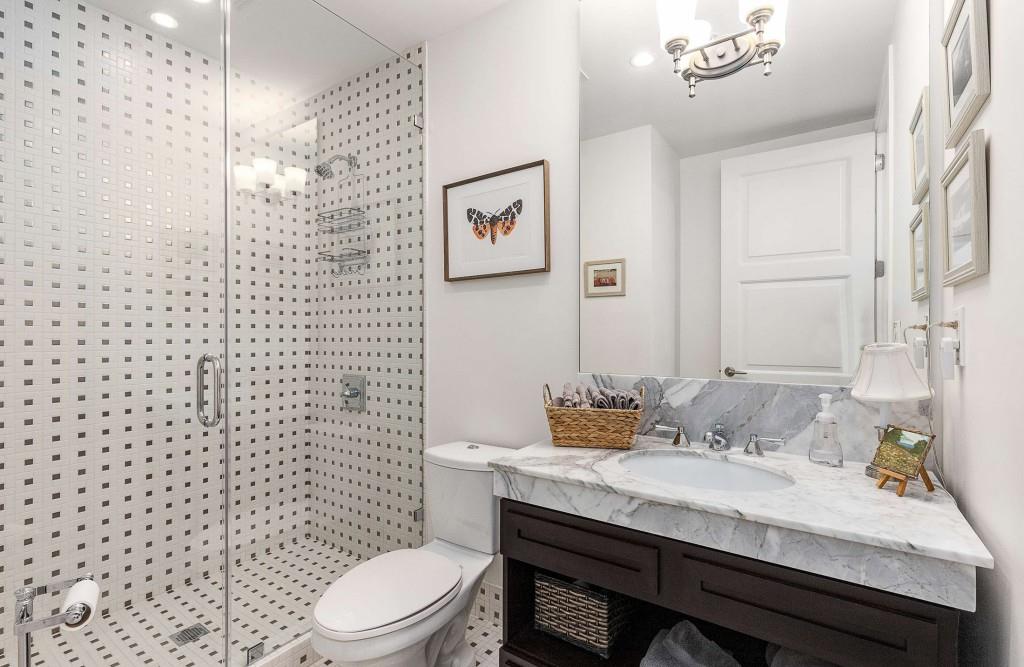 1820 Peachtree Road Northwest, Unit 1409 Atlanta, GA 30309 - Photo 25 of 44 a bathroom with a sink a toilet and shower curtain