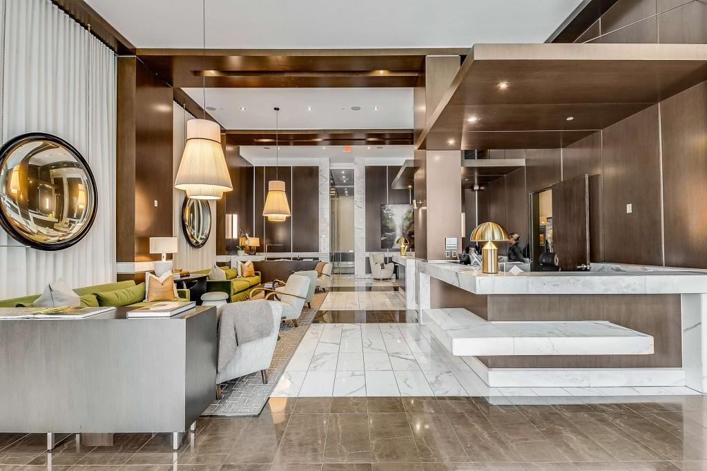 1820 Peachtree Road Northwest, Unit 1409 Atlanta, GA 30309 - Photo 29 of 44 a living room with large couches and kitchen view