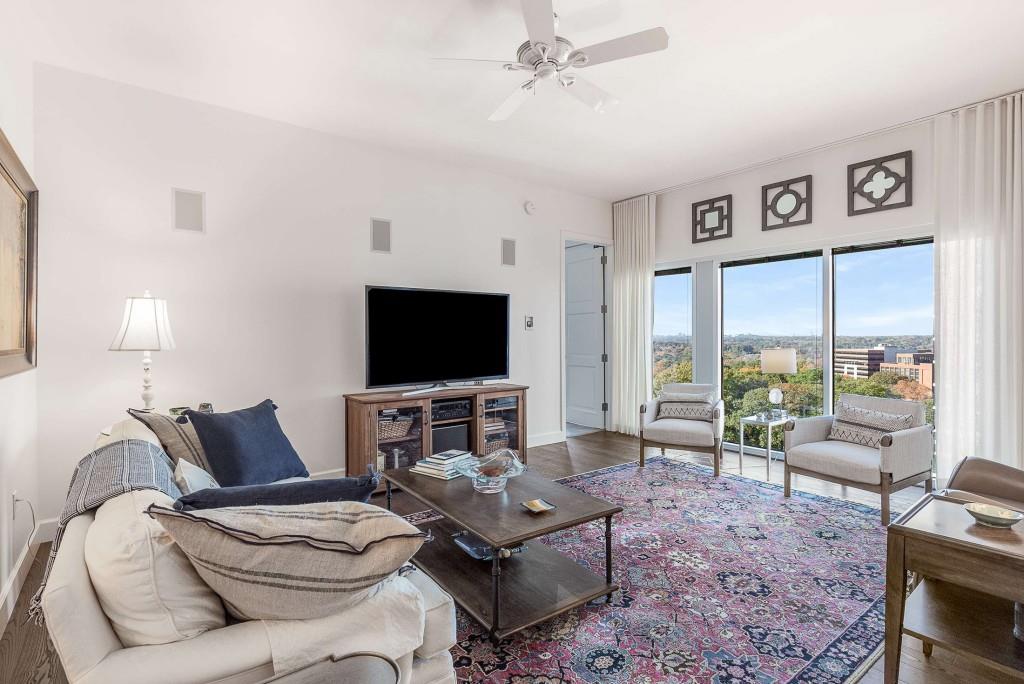 1820 Peachtree Road Northwest, Unit 1409 Atlanta, GA 30309 - Photo 3 of 44 a living room with furniture and a flat screen tv