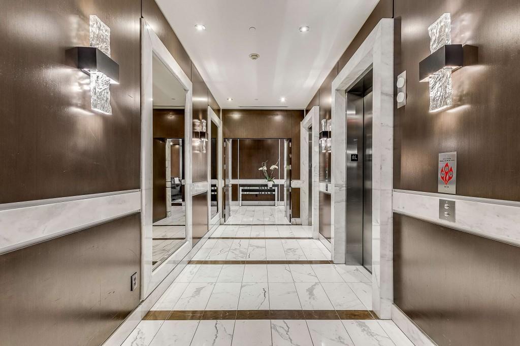 1820 Peachtree Road Northwest, Unit 1409 Atlanta, GA 30309 - Photo 31 of 44 a view of a hallway with dining area and chandelier