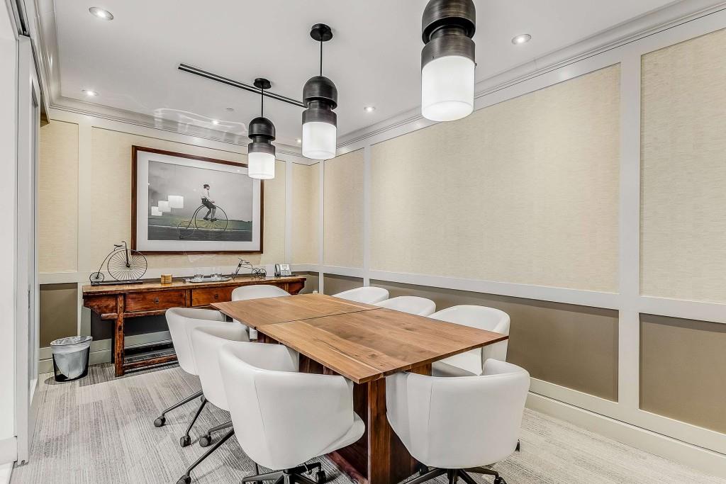 1820 Peachtree Road Northwest, Unit 1409 Atlanta, GA 30309 - Photo 32 of 44 a dining room with wooden floor a chandelier a wooden table and chairs