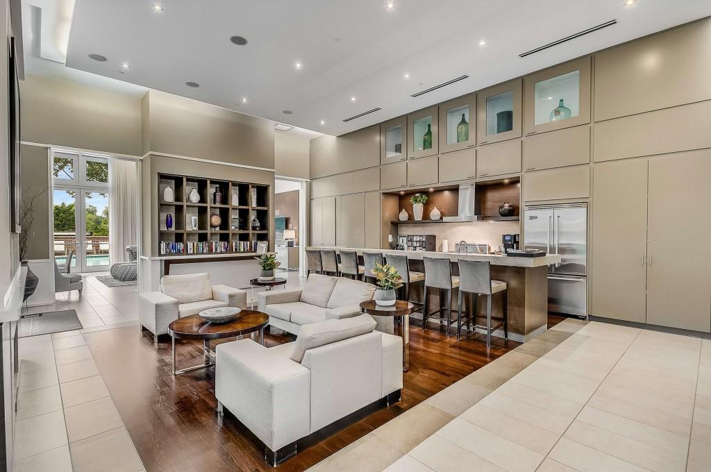 1820 Peachtree Road Northwest, Unit 1409 Atlanta, GA 30309 - Photo 35 of 44 a living room with stainless steel appliances kitchen island granite countertop a table chairs and a view of living room