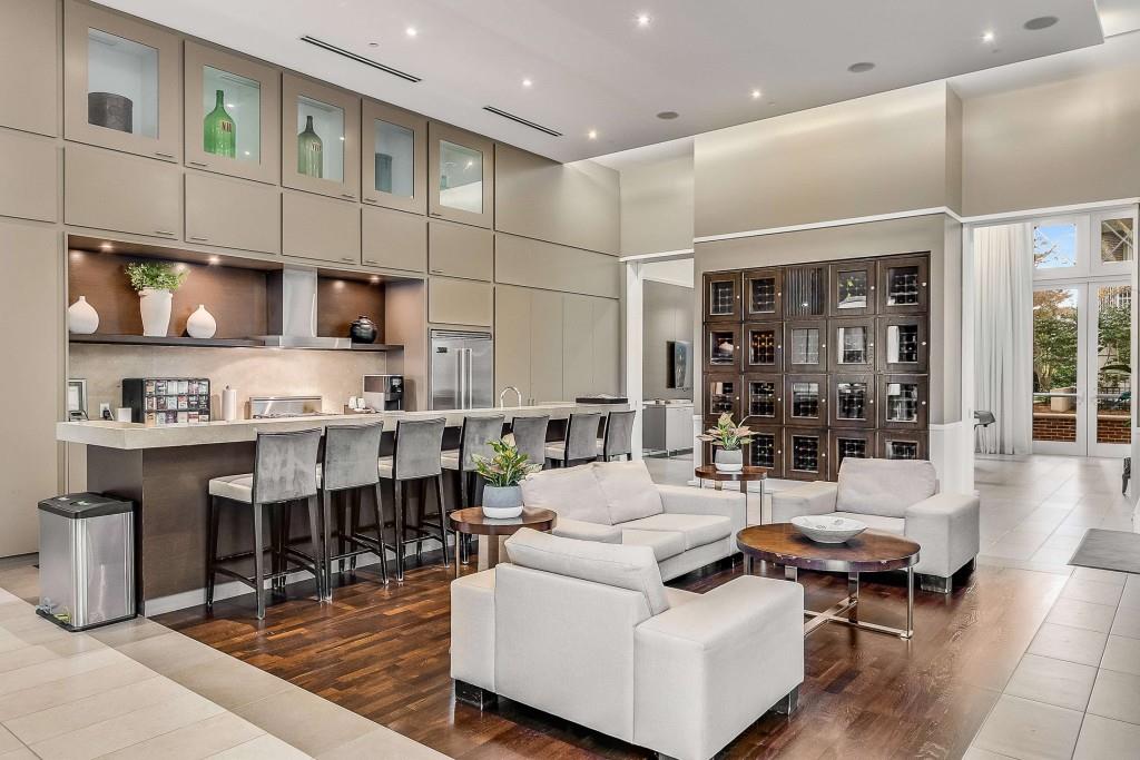 1820 Peachtree Road Northwest, Unit 1409 Atlanta, GA 30309 - Photo 36 of 44 a living room with stainless steel appliances kitchen island granite countertop a table chairs and a view of living room