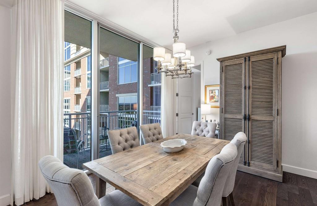 1820 Peachtree Road Northwest, Unit 1409 Atlanta, GA 30309 - Photo 6 of 44 a view of a dining room with furniture wooden floor and chandelier