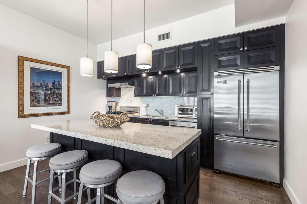 1820 Peachtree Road Northwest, Unit 1409 Atlanta, GA 30309 - Photo 8 of 44 a kitchen with stainless steel appliances a sink and a refrigerator