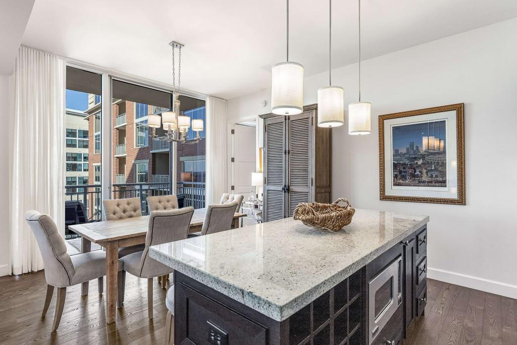 1820 Peachtree Road Northwest, Unit 1409 Atlanta, GA 30309 - Photo 9 of 44 a kitchen with granite countertop a table and chairs