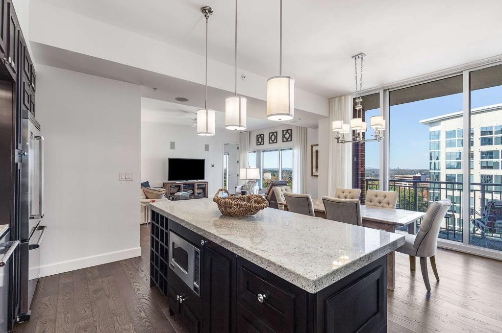 1820 Peachtree Road Northwest, Unit 1409 Atlanta, GA 30309 - Photo 10 of 44 a kitchen with kitchen island a large stove a sink and a refrigerator