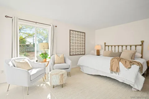 a spacious bedroom with a bed and a large window