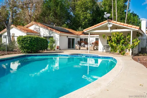 a view of a house with a yard patio and sitting area
