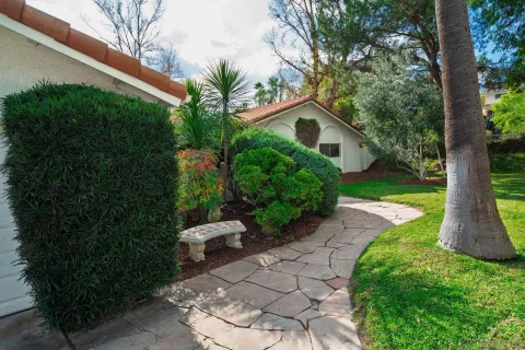 a view of a back yard with a house and garden