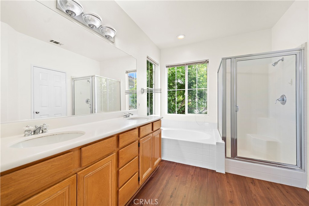 68 Kyle Court Ladera Ranch, CA 92694 - Photo 20 of 33 a bathroom with a granite countertop sink mirror and a bathtub