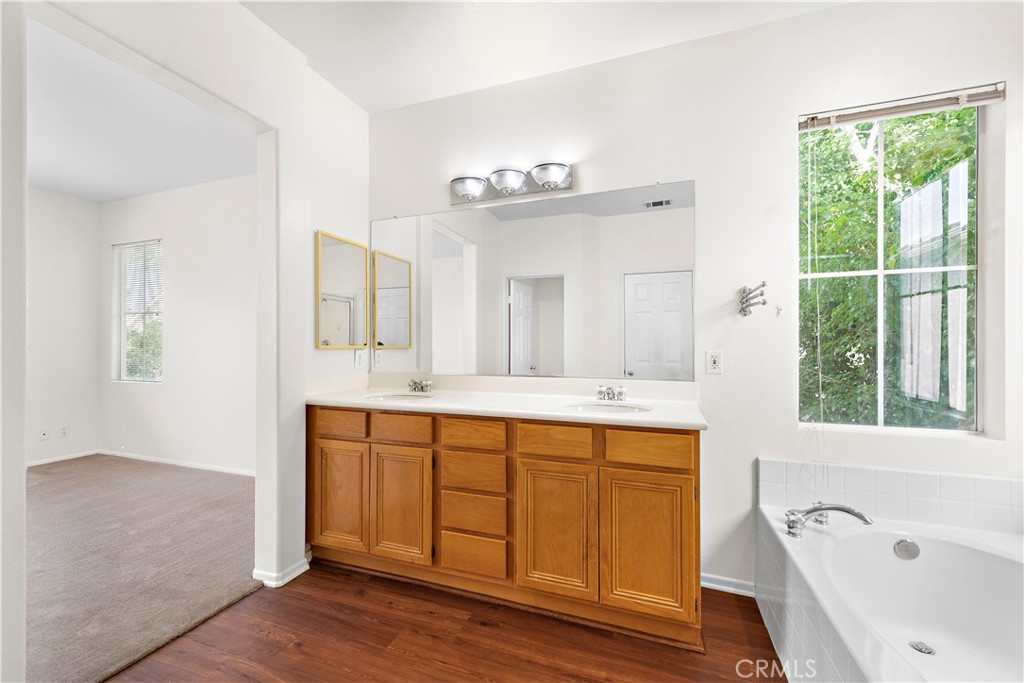 68 Kyle Court Ladera Ranch, CA 92694 - Photo 21 of 33 a spacious bathroom with a tub sink and mirror